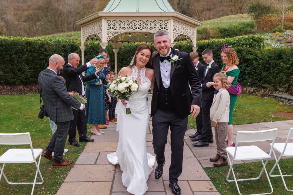 Couple smile after outdoor wedding Lodore Falls
