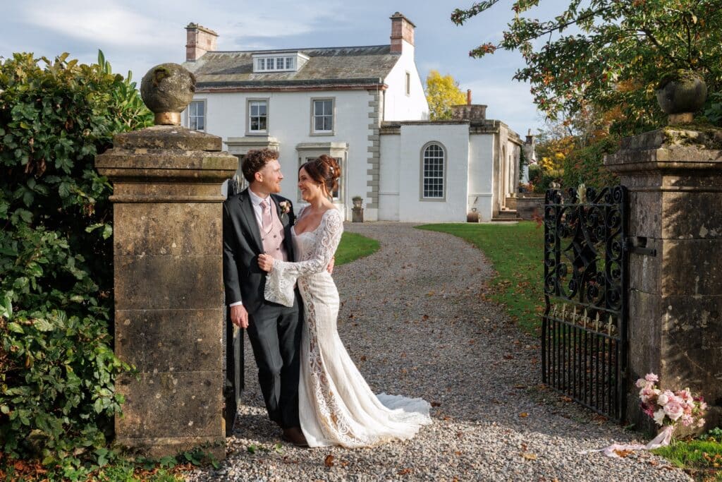 Couple embrace on the driveway to Holesfoot Wedding